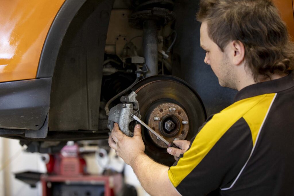 Mechanic checking suspension on a customer vehicle at Pascoe Mechanical Bayside
